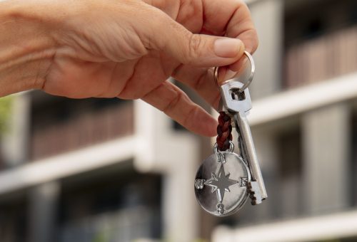 hand-holding-key-outdoors
