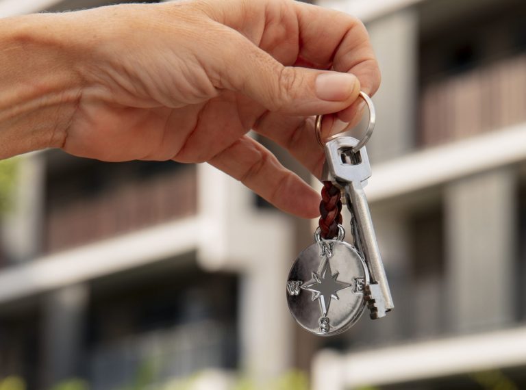 hand-holding-key-outdoors